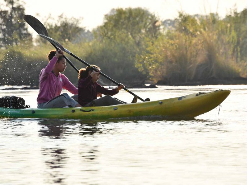 two people kayaking on river